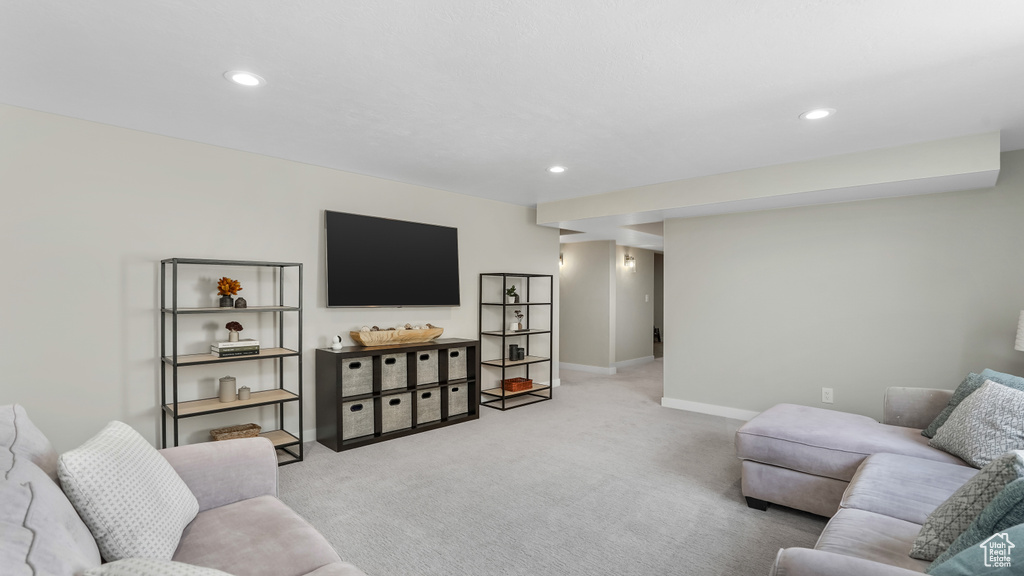 Living area with baseboards, light carpet, and recessed lighting