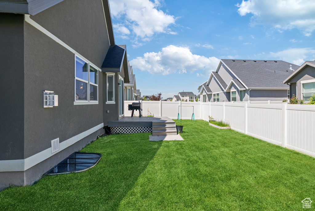 View of yard featuring a deck and a residential view