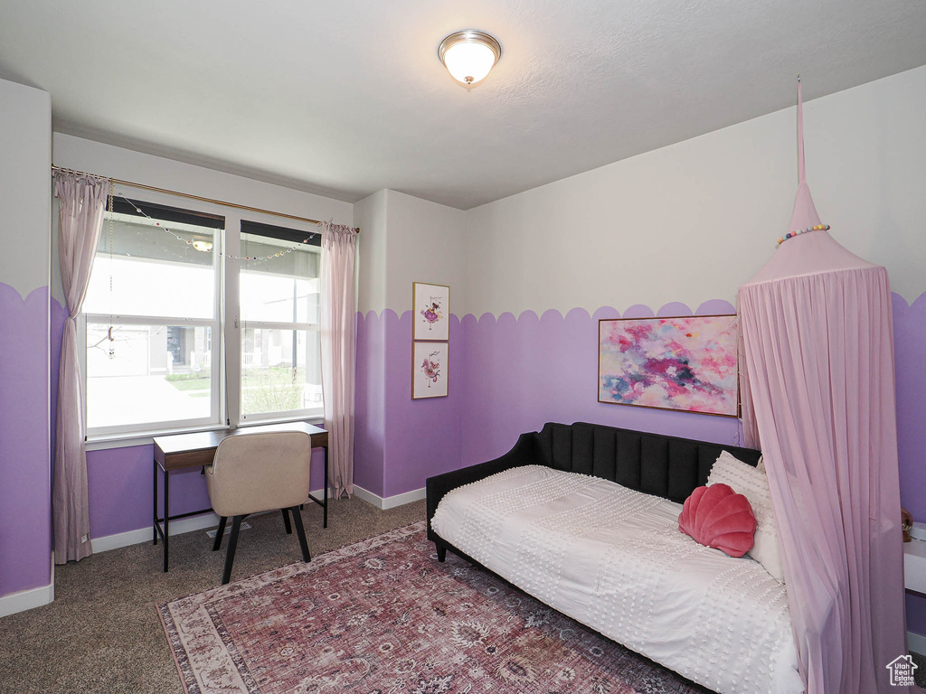 Bedroom featuring carpet floors and baseboards