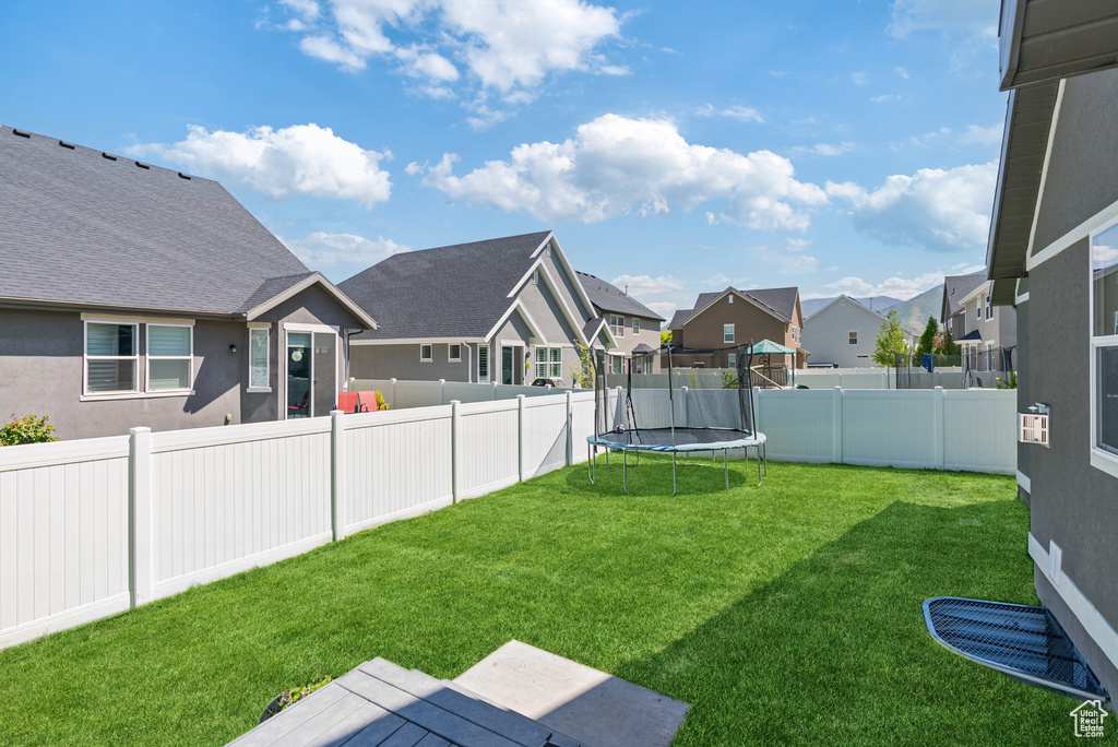 View of yard featuring a residential view and a trampoline