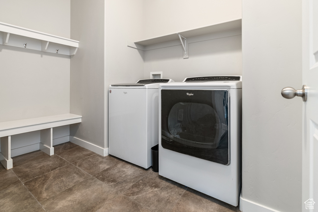 Washroom featuring separate washer and dryer and baseboards