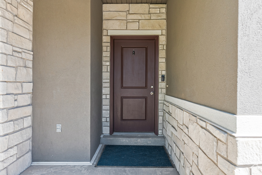Doorway to property featuring stone siding