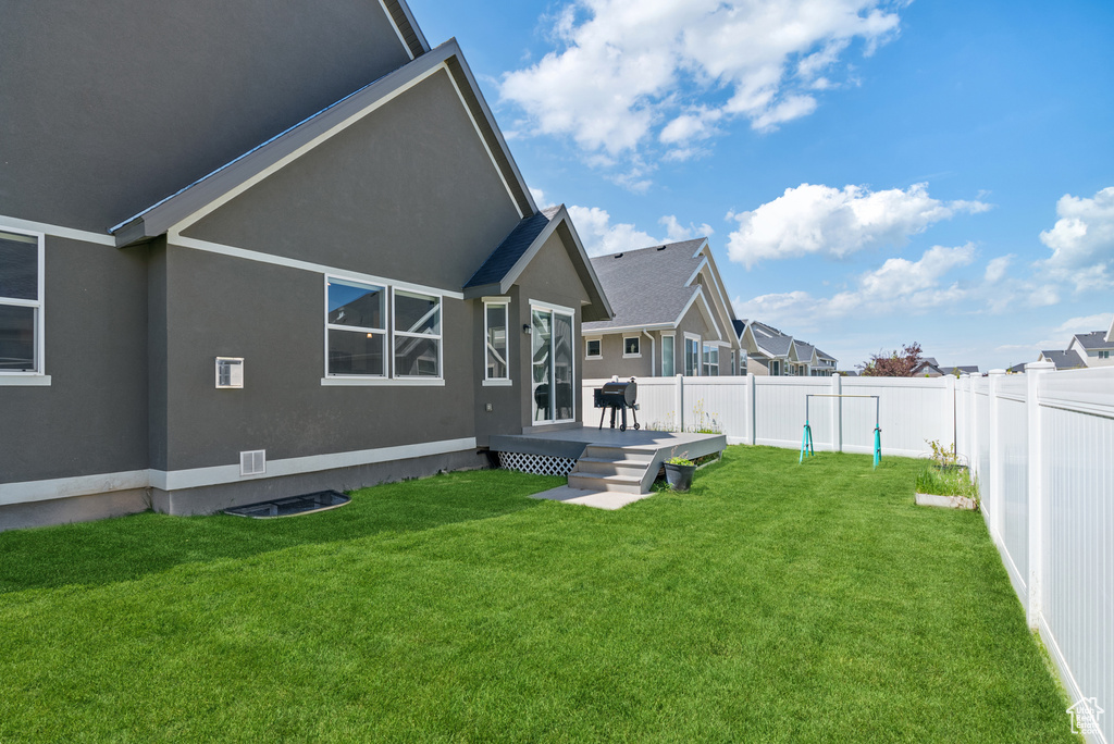 Back of property with stucco siding and a wooden deck