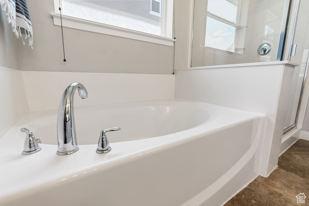 Full bath with a bath and a shower stall