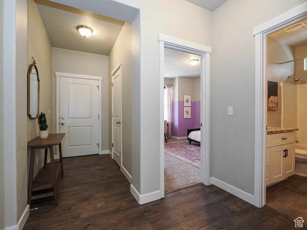 Hall with baseboards and dark wood-style flooring