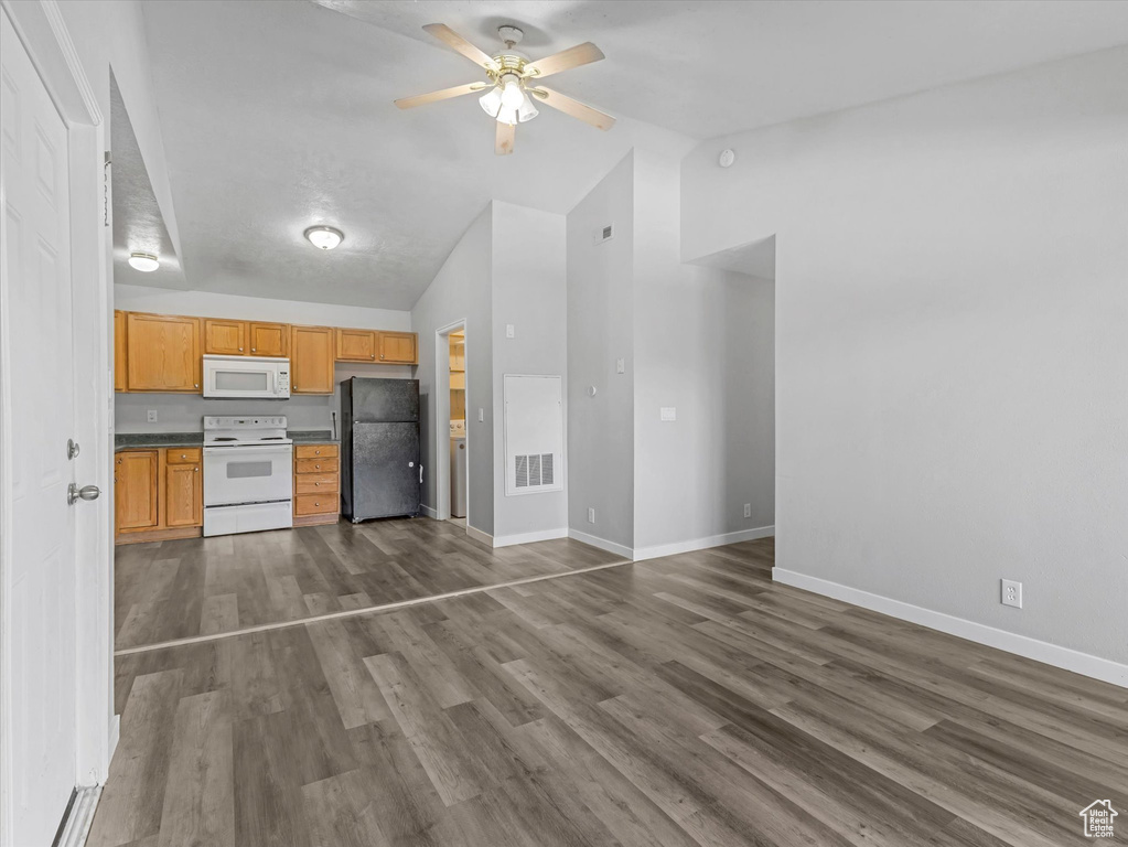 Unfurnished living room with a ceiling fan, baseboards, high vaulted ceiling, and dark wood-type flooring
