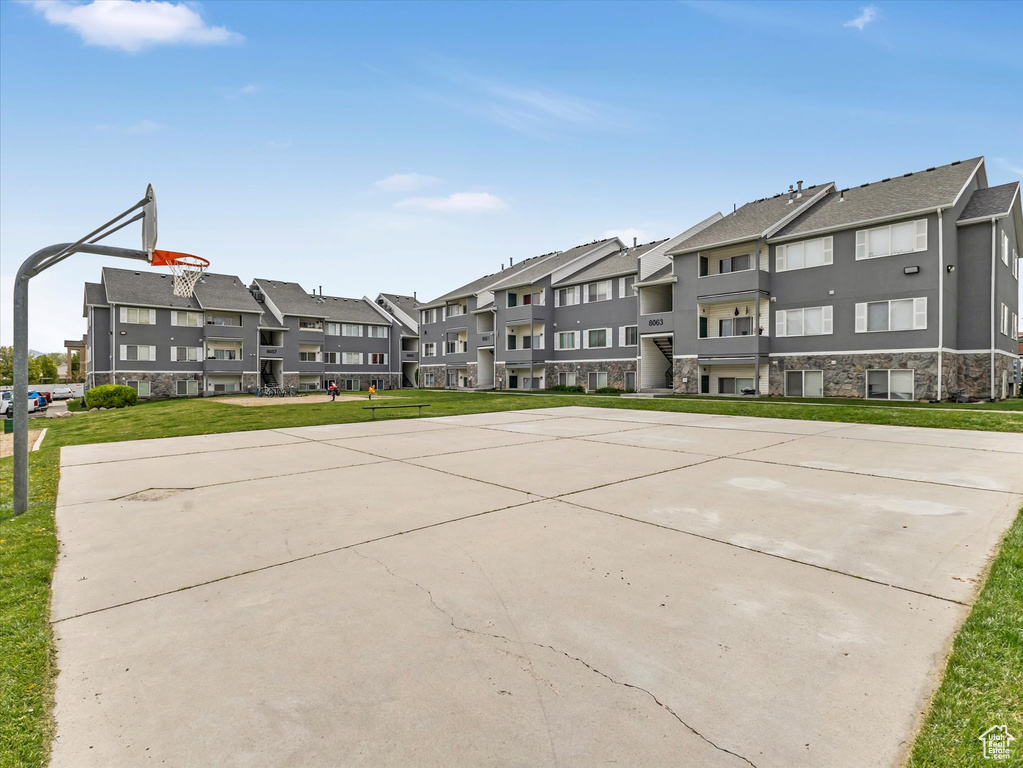 View of basketball court featuring community basketball court, a residential view, and a lawn