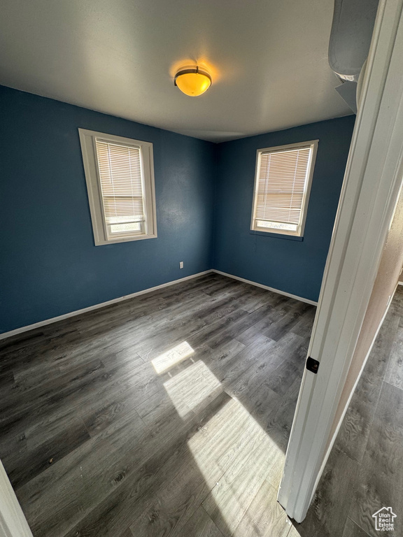 Spare room featuring wood finished floors and baseboards