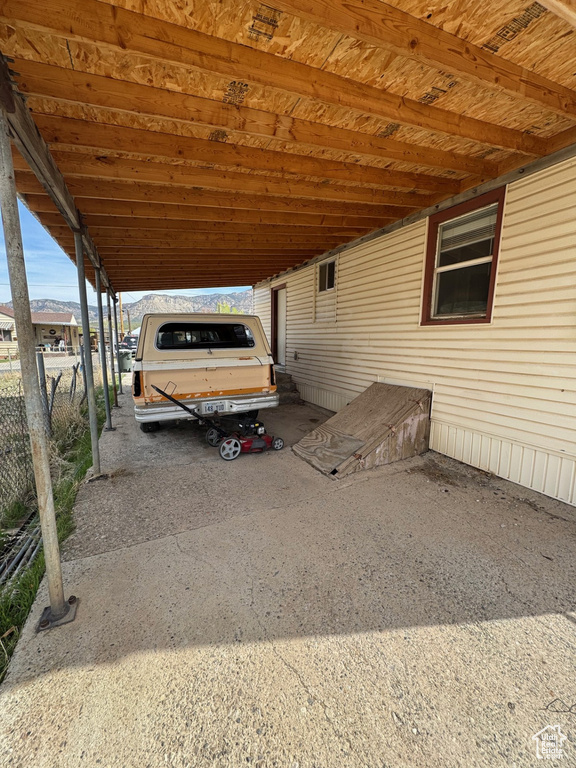View of parking with a carport