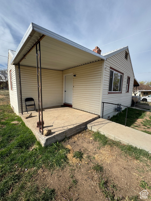 Exterior space featuring a chimney and a yard