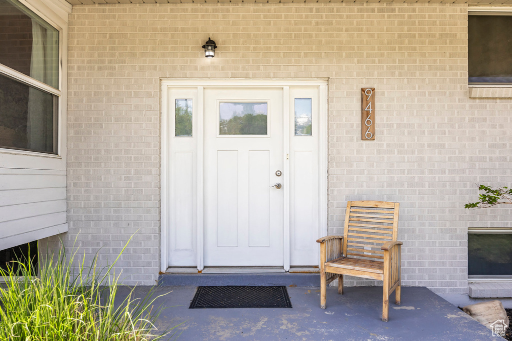 View of exterior entry featuring brick siding
