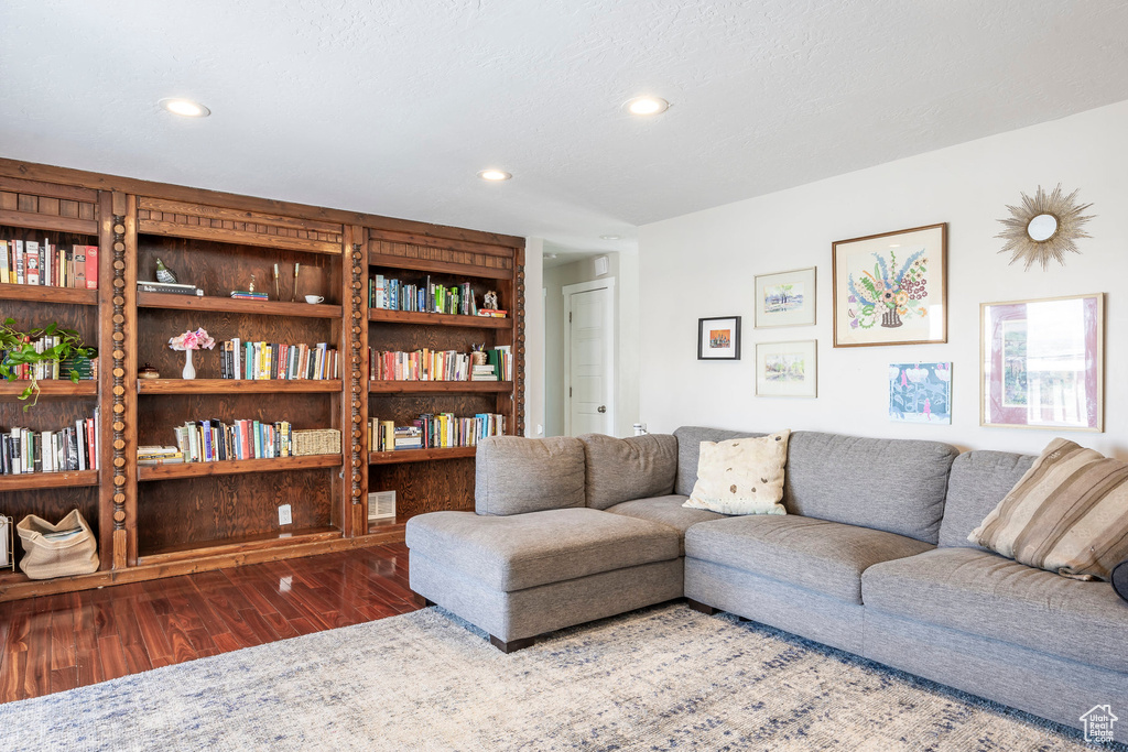 Living area featuring wood finished floors and recessed lighting