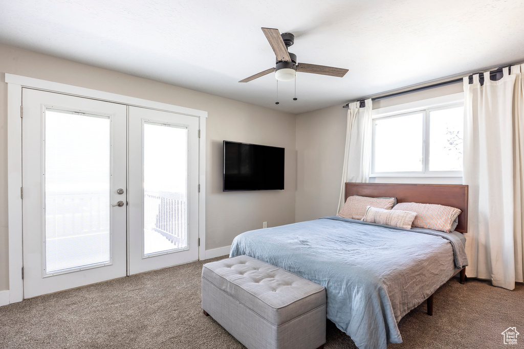 Carpeted bedroom with french doors, access to exterior, and ceiling fan