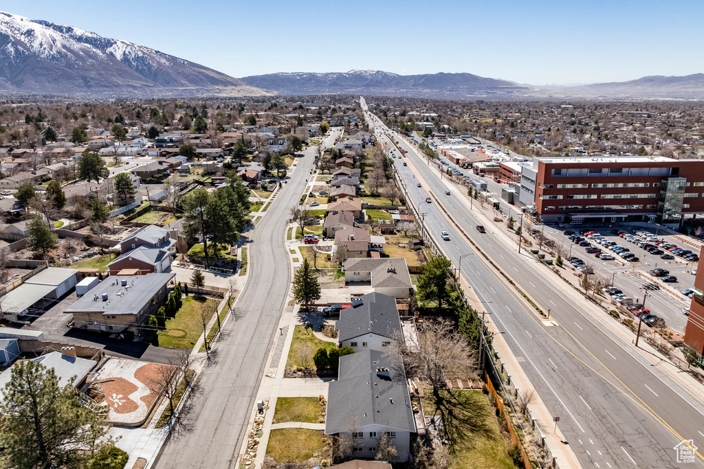 Aerial view of residential area with a major roadway and a mountain backdrop