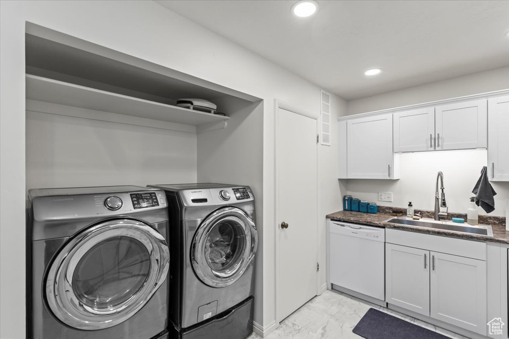 Washroom with recessed lighting, marble finish floor, laundry area, a sink, and independent washer and dryer