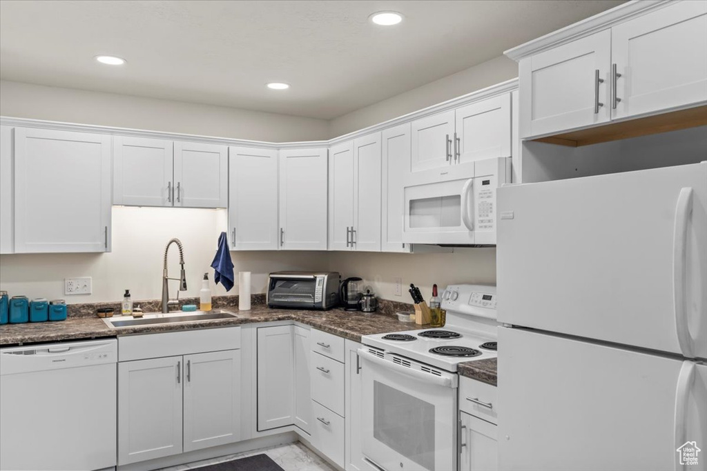 Kitchen featuring a sink, white appliances, a toaster, white cabinets, and recessed lighting