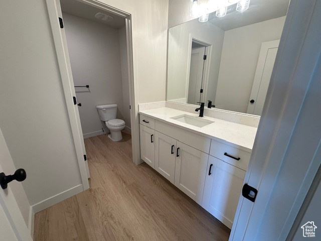 Bathroom featuring vanity and wood finished floors