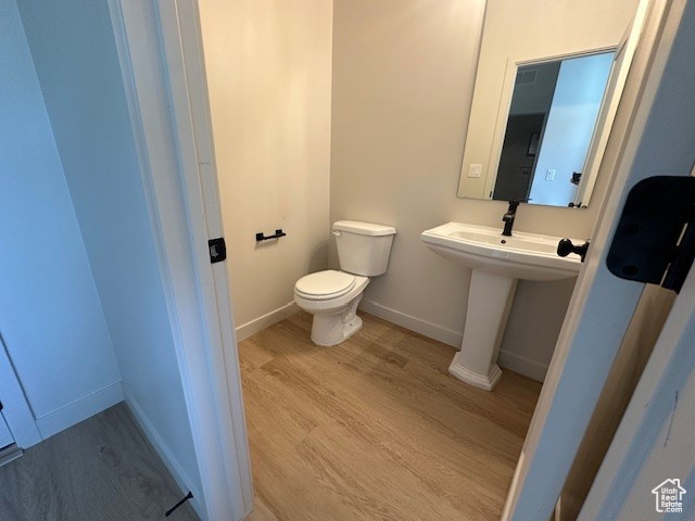 Bathroom featuring toilet and wood finished floors