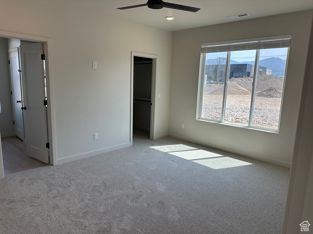 Unfurnished bedroom with carpet and ceiling fan
