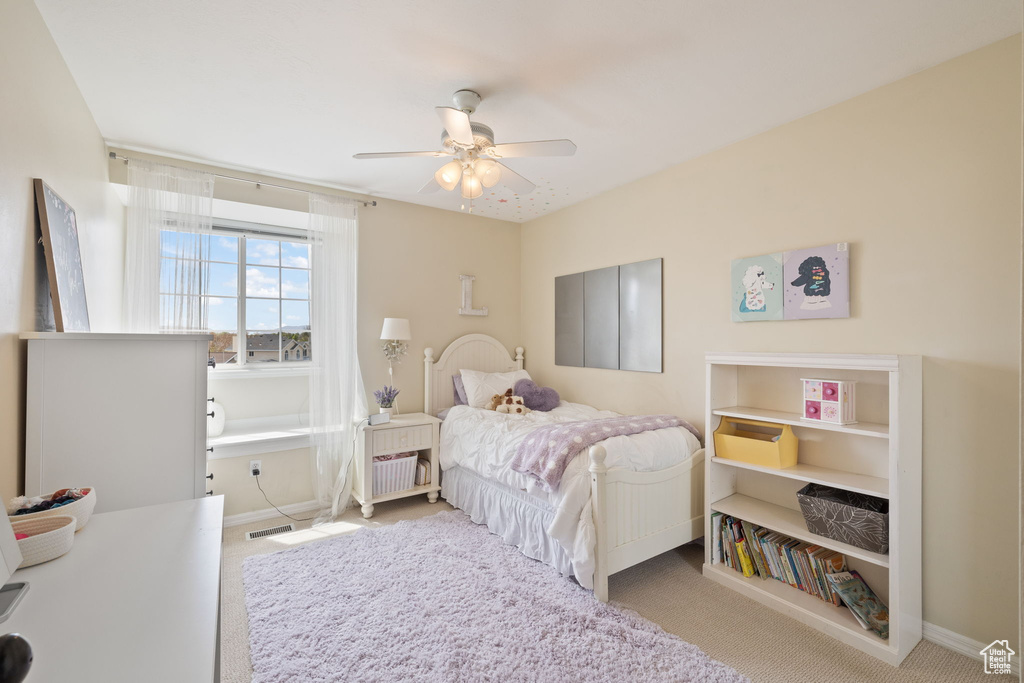 Bedroom with baseboards, carpet flooring, and ceiling fan