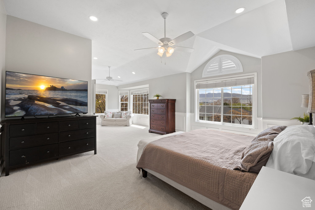 Bedroom with ceiling fan, a wainscoted wall, light colored carpet, lofted ceiling, and recessed lighting