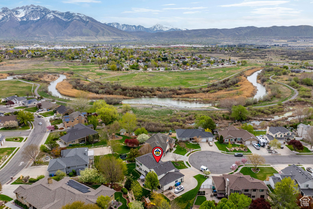 Drone / aerial view featuring a water and mountain view and a residential view