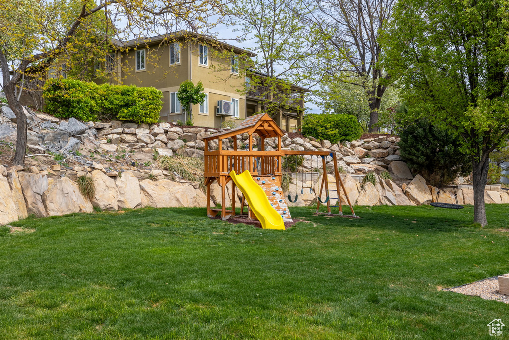 View of playground with a lawn