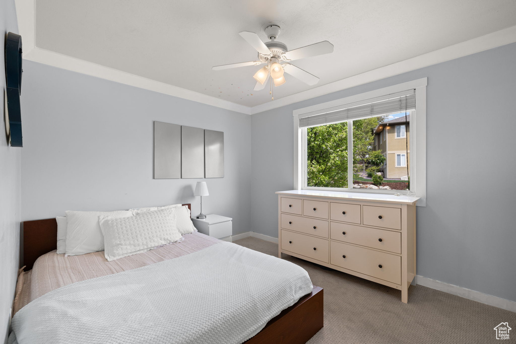 Bedroom featuring baseboards, carpet, and ceiling fan
