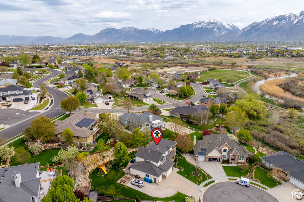 Birds eye view of property with a mountain view and a residential view