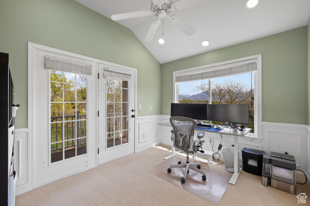 Carpeted office space featuring vaulted ceiling, a decorative wall, ceiling fan, a wainscoted wall, and recessed lighting