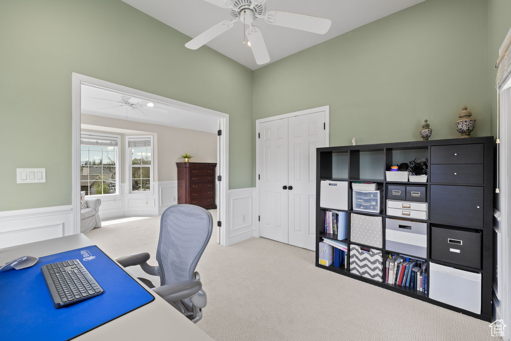 Office featuring carpet floors, a ceiling fan, and wainscoting
