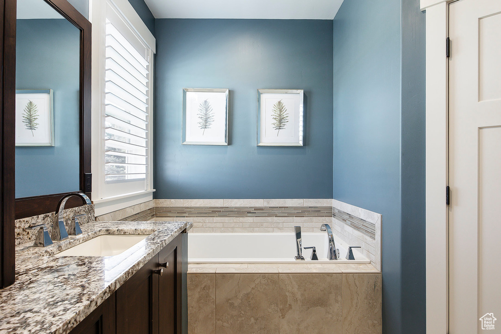 Full bathroom featuring vanity and a garden tub