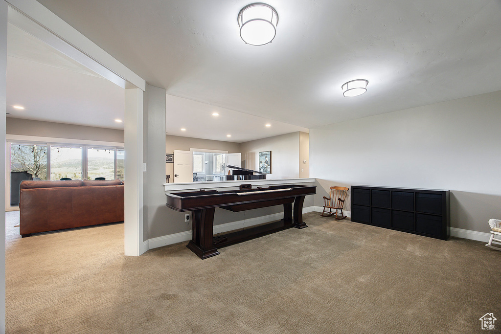 Recreation room featuring carpet floors, baseboards, and recessed lighting