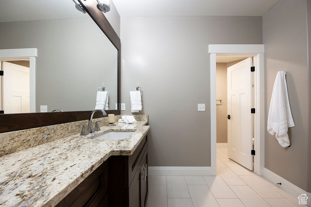 Bathroom featuring vanity and baseboards