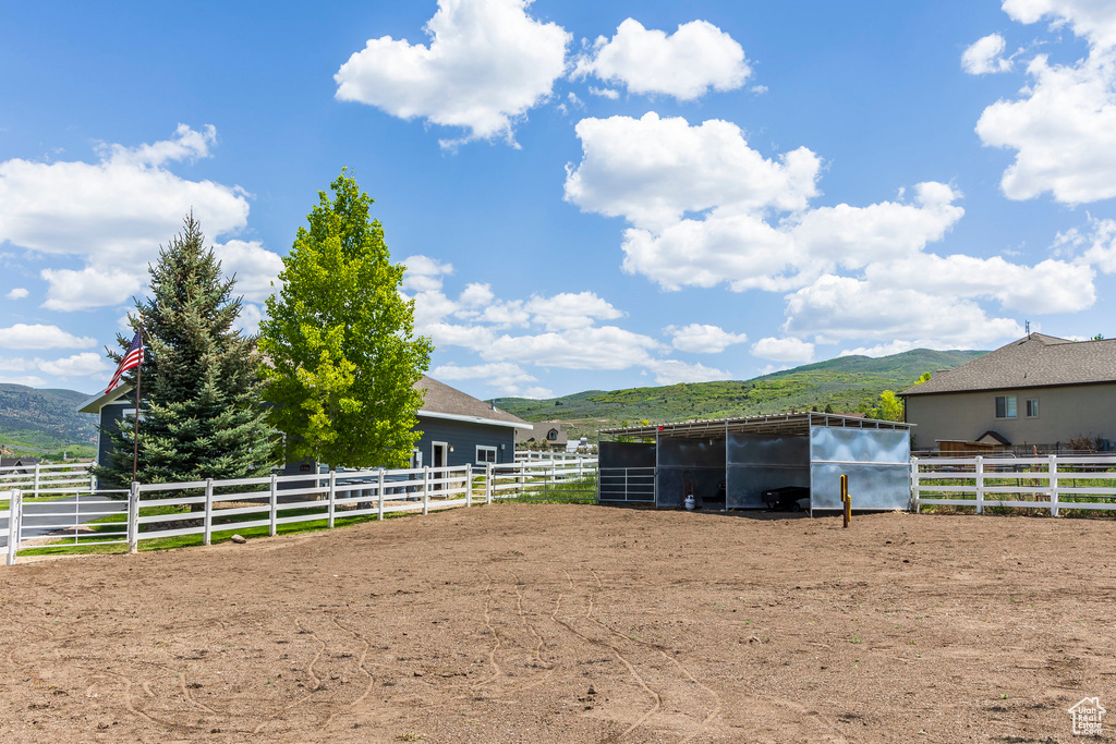 Stable featuring a mountain view and a view of rural / pastoral area