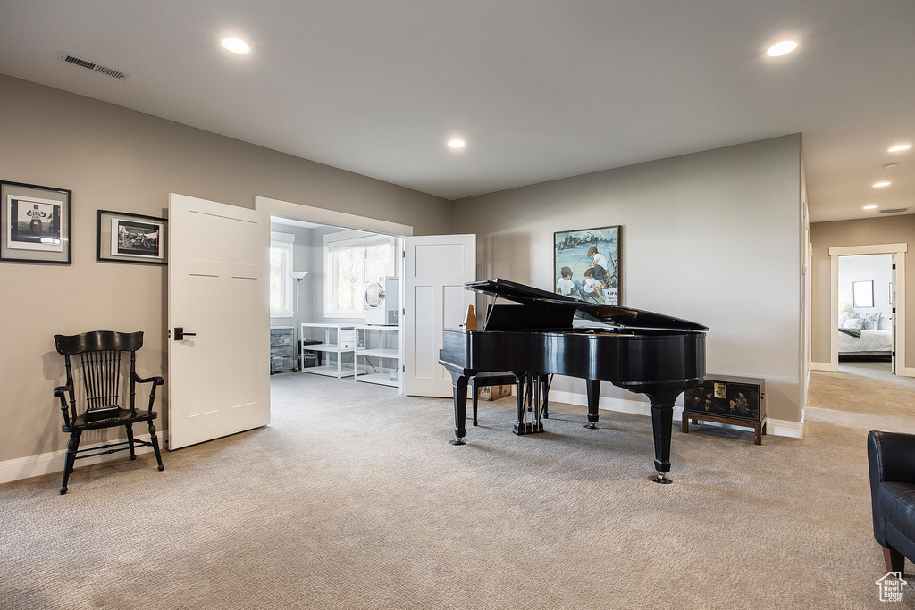 Sitting room featuring light carpet, baseboards, and recessed lighting