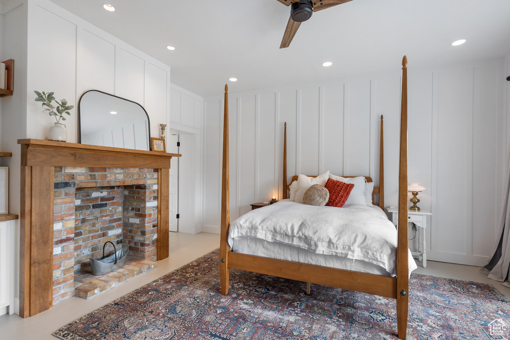 Bedroom featuring recessed lighting, ceiling fan, and a decorative wall
