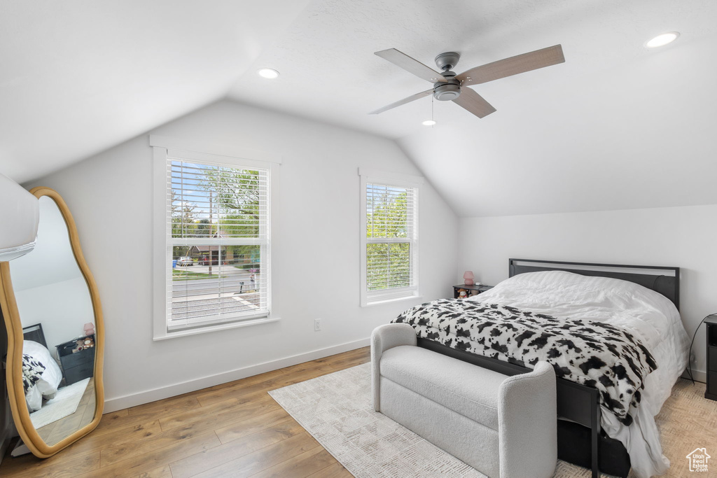 Bedroom with light wood-style floors, ceiling fan, baseboards, lofted ceiling, and recessed lighting