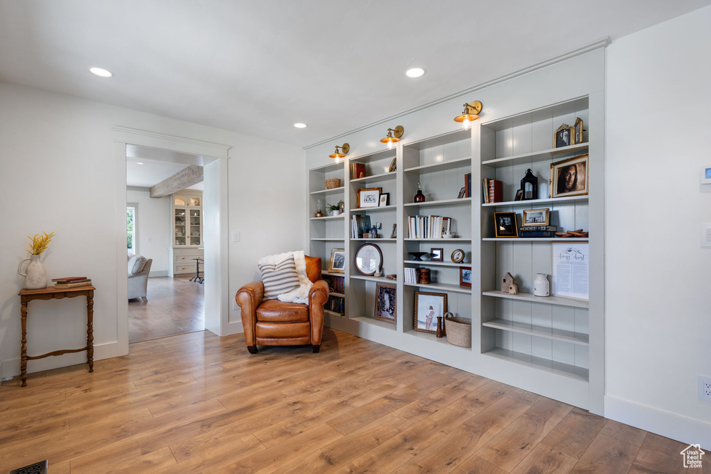 Living area featuring wood-type flooring, baseboards, and recessed lighting