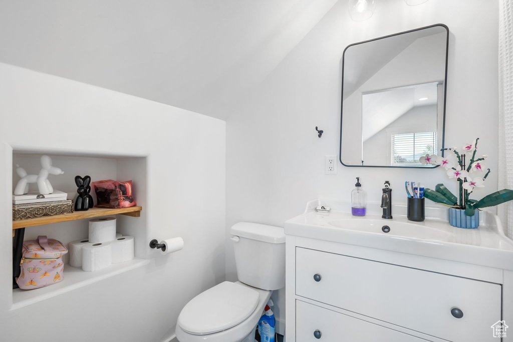 Half bathroom featuring toilet and vanity