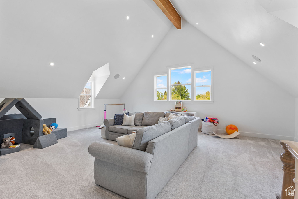 Living room featuring plenty of natural light, lofted ceiling with beams, baseboards, carpet flooring, and recessed lighting