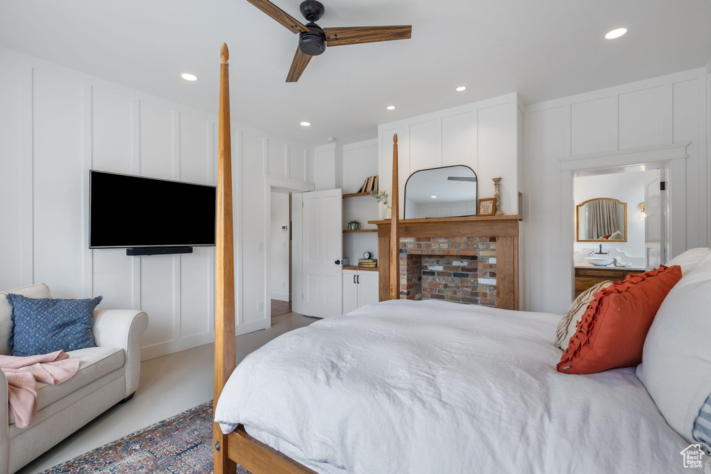 Bedroom featuring a decorative wall, a ceiling fan, and recessed lighting