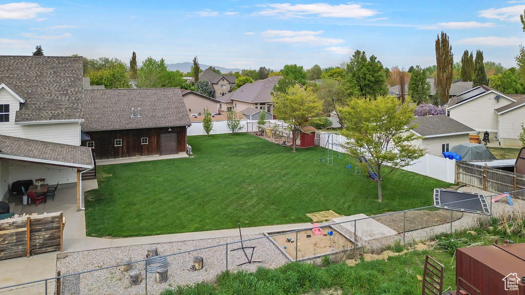 View of yard featuring a fenced backyard, a residential view, and a patio