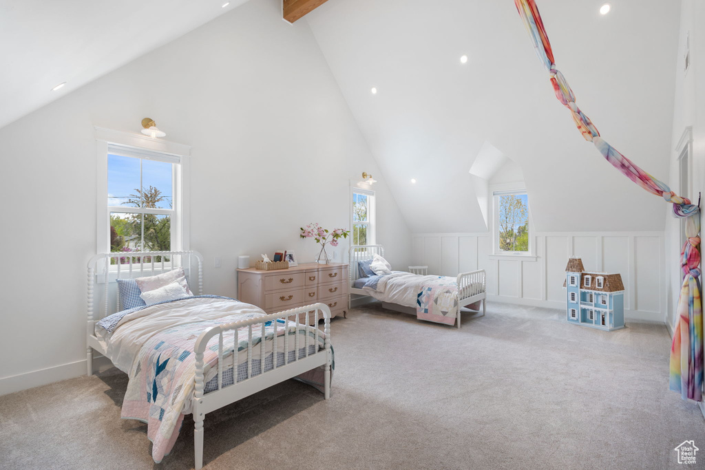 Carpeted bedroom featuring beamed ceiling, high vaulted ceiling, and recessed lighting