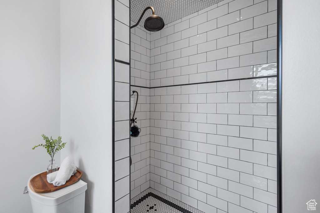Bathroom with toilet and tiled shower