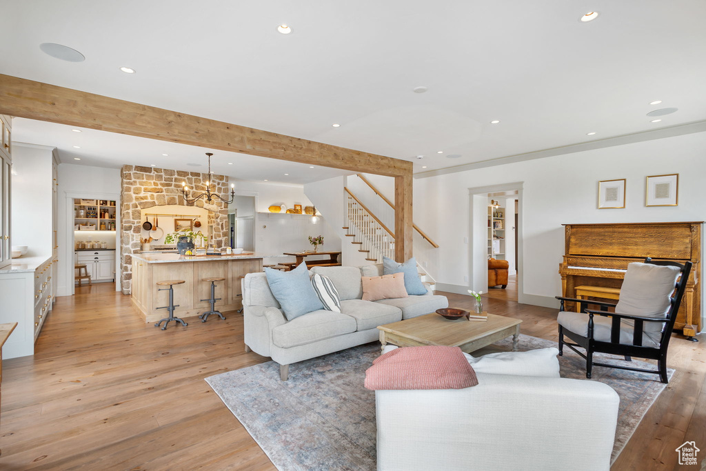 Living room with stairway, light wood-style flooring, and recessed lighting