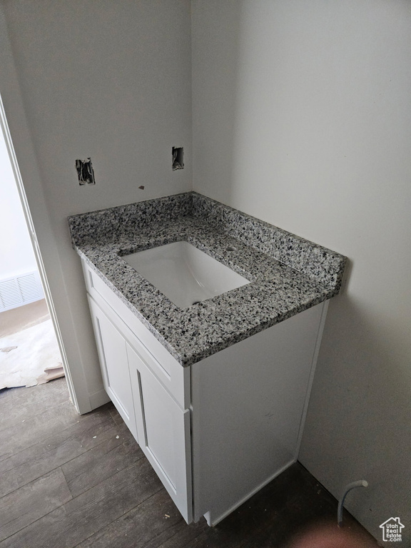 Bathroom featuring wood finished floors and vanity
