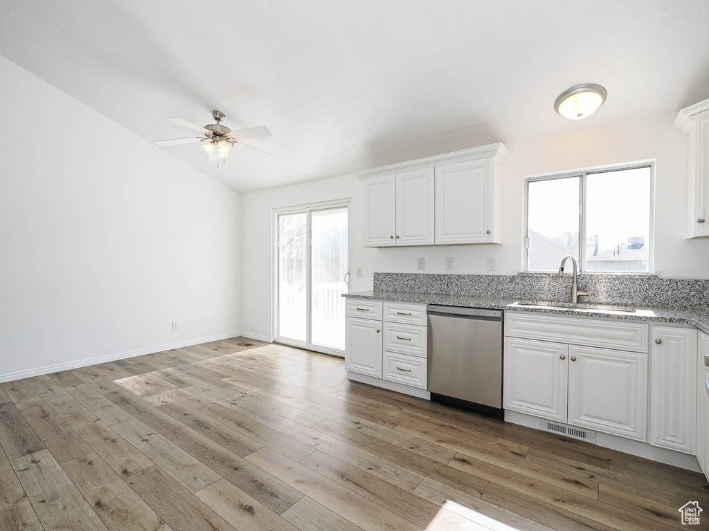 Kitchen featuring white cabinets, dishwasher, visible vents, a ceiling fan, and a sink