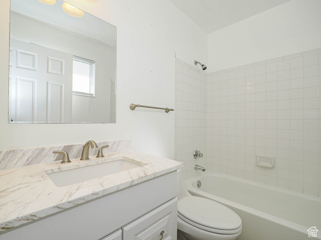 Full bathroom with toilet, vanity, and shower / bathing tub combination
