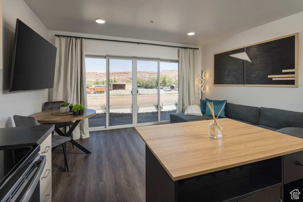 Living room with recessed lighting and dark wood finished floors